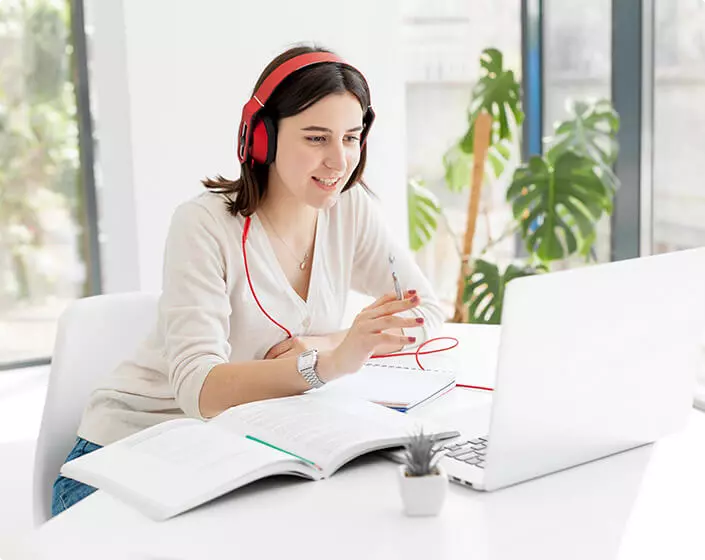 The girl works for a laptop